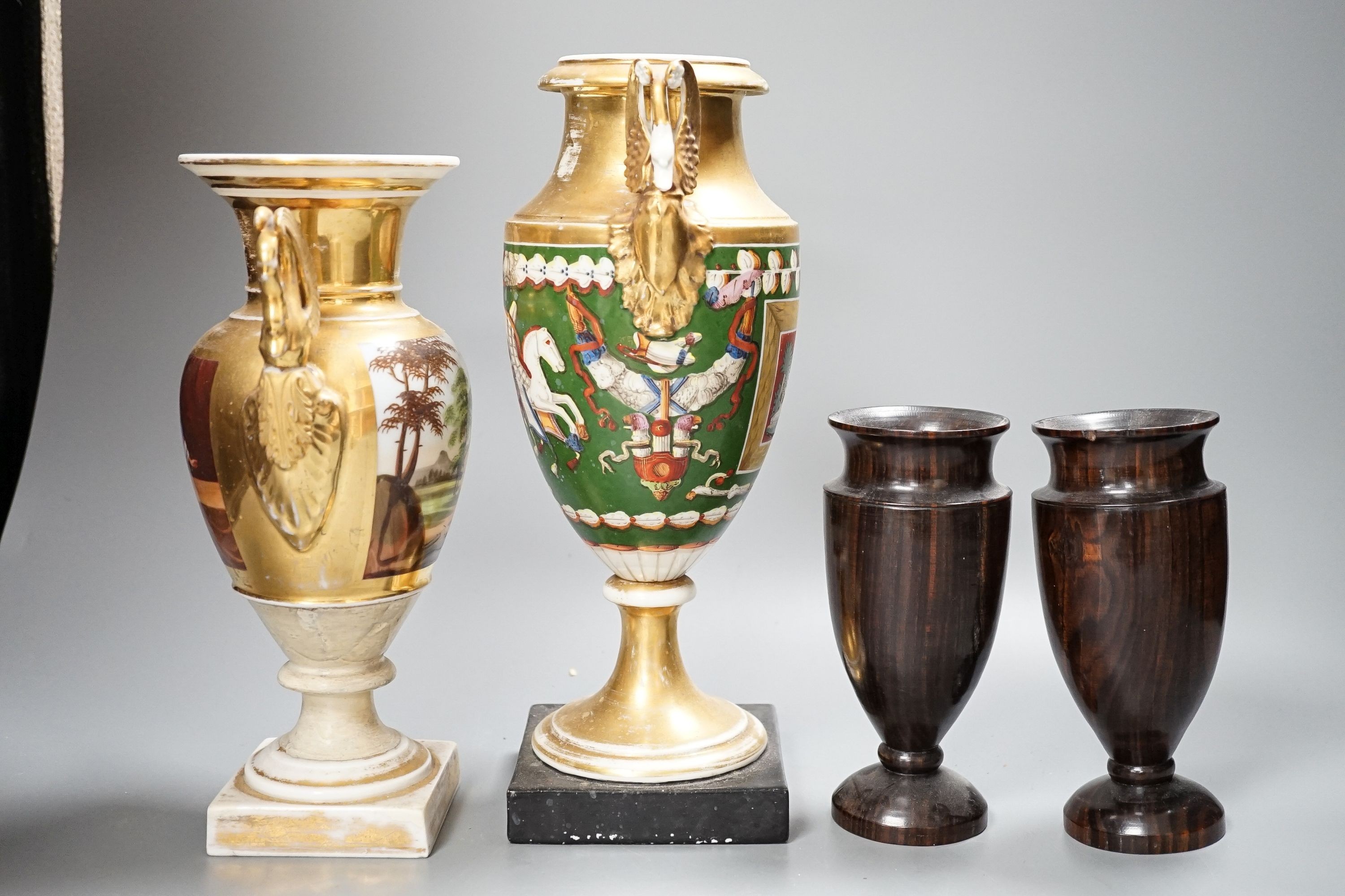 Two 19th century Paris porcelain gilt decorated swan-handled vases and a pair of turned ebony vases, tallest 28cm